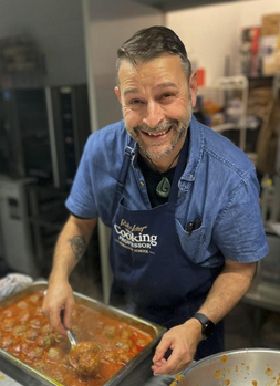 a man cooking in a kitchen preparing food