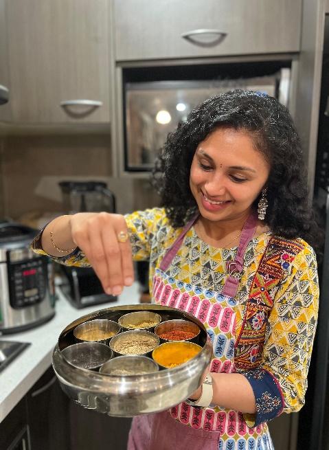 a woman cooking food in a kitchen